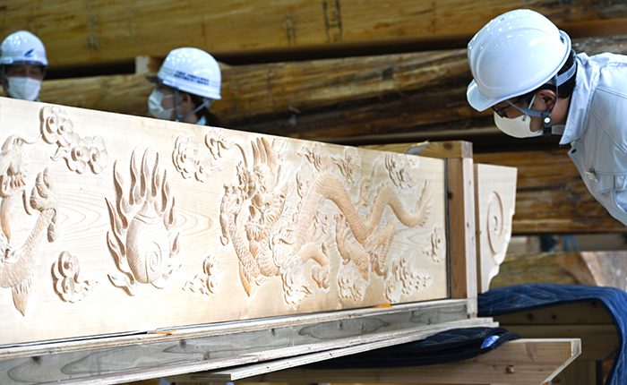 木材倉庫・原寸場に搬入された龍などの彫刻が施された天井額木=2023年8月7日(又吉康秀撮影)